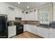 Updated kitchen with white cabinets, tile backsplash, and wood-look flooring at 53573 W Fresno Rd, Maricopa, AZ 85139