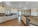Open kitchen with white cabinets, stainless steel dishwasher and decorative backsplash at 53573 W Fresno Rd, Maricopa, AZ 85139