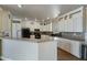 A kitchen featuring white cabinets, tile backsplash, and black appliances at 53573 W Fresno Rd, Maricopa, AZ 85139