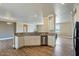 Bright kitchen featuring white cabinets, stainless steel dishwasher and decorative backsplash at 53573 W Fresno Rd, Maricopa, AZ 85139