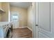 Well-equipped laundry room with modern washer, dryer, and access to the backyard at 53573 W Fresno Rd, Maricopa, AZ 85139