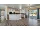 Bright living room with wood flooring and sliding glass doors to the backyard at 53573 W Fresno Rd, Maricopa, AZ 85139