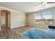 Bright living room featuring wood flooring, large windows and a blue patterned rug at 53573 W Fresno Rd, Maricopa, AZ 85139