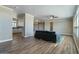 An open floor plan connects the living room with the kitchen in a space with wood floors and neutral paint at 53573 W Fresno Rd, Maricopa, AZ 85139