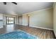 Spacious living room features wood floors, neutral walls, recessed lighting, and large glass doors to the backyard at 53573 W Fresno Rd, Maricopa, AZ 85139