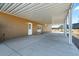 Covered patio with concrete flooring, offering a spacious outdoor living and entertaining area at 53573 W Fresno Rd, Maricopa, AZ 85139