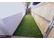 Artificial turf creates a backyard play space, bordered by a wood fence at 5458 W El Caminito Dr, Glendale, AZ 85302