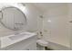Bright bathroom featuring a shower-tub combo and a white vanity with a round mirror at 5458 W El Caminito Dr, Glendale, AZ 85302