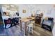 Stylish open-concept dining area with modern table, breakfast bar, and adjacent kitchen at 5458 W El Caminito Dr, Glendale, AZ 85302