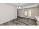 Bright dining room with gray wood flooring and french doors to outdoor space at 5458 W El Caminito Dr, Glendale, AZ 85302