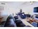 Spacious open-concept living room with modern flooring, ceiling fans, and comfortable seating at 5458 W El Caminito Dr, Glendale, AZ 85302
