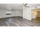 Bright living room with gray wood floors, ceiling fans, and ample natural light at 5458 W El Caminito Dr, Glendale, AZ 85302