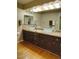 Bathroom vanity with and vessel sinks, granite countertop, and wood cabinets at 5824 N Scottsdale Rd, Paradise Valley, AZ 85253