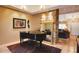 Elegant living space with piano, stone column, and view to the living room beyond at 5824 N Scottsdale Rd, Paradise Valley, AZ 85253