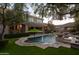 Spacious backyard oasis with a sparkling pool, stone decking, and a lush green lawn at 60 W Tonto Dr, Chandler, AZ 85248