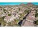 An aerial view of a community showcasing well-maintained homes, landscaping, and mountain views in the distance at 6931 W Antelope Dr, Peoria, AZ 85383