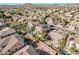 Aerial view of a suburban neighborhood with manicured lawns, mature trees, and mountain views at 6931 W Antelope Dr, Peoria, AZ 85383