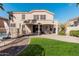 Beautiful backyard featuring a covered patio, green grass, brick flooring, and a safety fence around the pool at 6931 W Antelope Dr, Peoria, AZ 85383
