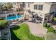 Aerial view of a spacious backyard featuring a pool, covered patio, and lush green lawn at 6931 W Antelope Dr, Peoria, AZ 85383