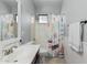 Cozy bathroom showcasing single sink vanity, tiled shower, neutral tile floor, and nautical-themed shower curtain at 6931 W Antelope Dr, Peoria, AZ 85383