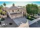 Impressive home with a three-car garage, lush landscaping, and a tiled roof, showcasing curb appeal at 6931 W Antelope Dr, Peoria, AZ 85383