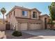 Charming two-story home with a three car garage, desert landscaping, and tiled roof details at 6931 W Antelope Dr, Peoria, AZ 85383