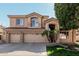 Charming two-story home with a three car garage, desert landscaping, and tiled roof details at 6931 W Antelope Dr, Peoria, AZ 85383