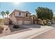 Charming two-story home with a three car garage, desert landscaping, and tiled roof details at 6931 W Antelope Dr, Peoria, AZ 85383