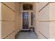 Inviting front entry with dark wood door, stone accents, and neutral color scheme at 6931 W Antelope Dr, Peoria, AZ 85383