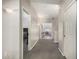Hallway with neutral paint, carpet, and access to multiple rooms in the home at 6931 W Antelope Dr, Peoria, AZ 85383