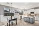 Open kitchen and dining area with stainless steel appliances, white cabinets, and a gray kitchen island at 6931 W Antelope Dr, Peoria, AZ 85383