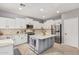Well-appointed kitchen boasts a functional center island, stainless steel appliances, and white cabinets at 6931 W Antelope Dr, Peoria, AZ 85383