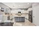 Spacious kitchen features a large island, stainless steel appliances, and pristine white cabinetry at 6931 W Antelope Dr, Peoria, AZ 85383
