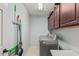 Functional laundry room features cabinets and stainless steel washer and dryer at 6931 W Antelope Dr, Peoria, AZ 85383