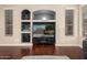 Built in media center with display shelving in the large and open living room at 6931 W Antelope Dr, Peoria, AZ 85383