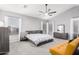 Light-filled main bedroom features a ceiling fan, carpet floors, and a modern design at 6931 W Antelope Dr, Peoria, AZ 85383