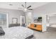 Spacious main bedroom with a ceiling fan, TV, and a comfy seating area at 6931 W Antelope Dr, Peoria, AZ 85383