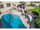 Aerial view of a private pool with lounge chairs and umbrellas, surrounded by lush landscaping at 6931 W Antelope Dr, Peoria, AZ 85383