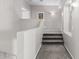 Carpeted staircase features neutral colored walls, white trim, and access to the upper level of the home at 6931 W Antelope Dr, Peoria, AZ 85383