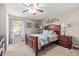 Comfortable bedroom featuring a ceiling fan and a large window for natural light at 7454 E Pueblo Ave, Mesa, AZ 85208