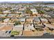 Expansive aerial shot of a residential neighborhood with a highway nearby, showcasing the homes, streets, and surrounding landscape at 7538 E Carol Cir, Mesa, AZ 85208