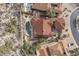 Overhead shot showcases a residence with red tile roof, pool, and spa, surrounded by desert flora and neighboring homes at 7546 E Camino Puesta Del Sol --, Scottsdale, AZ 85266