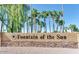 Stone monument displaying the community's name, Fountain of the Sun, framed by palm trees and blue skies at 7861 E Fountain Cv, Mesa, AZ 85208