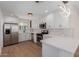 Modern kitchen with stainless steel appliances, white cabinets and countertops, and hardwood floors at 821 W Missouri Ave, Phoenix, AZ 85013