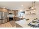 Well-lit kitchen with a large window, island, stainless steel appliances, and modern finishes at 849 S Santa Barbara --, Mesa, AZ 85202