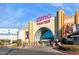 Inviting entrance to AMC Theatres, with its grand archway, movie posters, and landscaping enhancing curb appeal at 8516 W Peppertree Ln, Glendale, AZ 85305