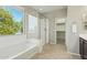 Bright bathroom with a shower, tub and walk in closet; natural light fills the room at 8516 W Peppertree Ln, Glendale, AZ 85305