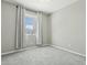 Neutral bedroom with carpet, curtains and a large window bringing in natural light at 8516 W Peppertree Ln, Glendale, AZ 85305