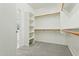 A walk in closet provides ample shelving and space for an organized wardrobe at 8516 W Peppertree Ln, Glendale, AZ 85305
