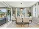 Bright dining area with sliding glass doors to the backyard, stylish light fixture, and seating for six at 8516 W Peppertree Ln, Glendale, AZ 85305